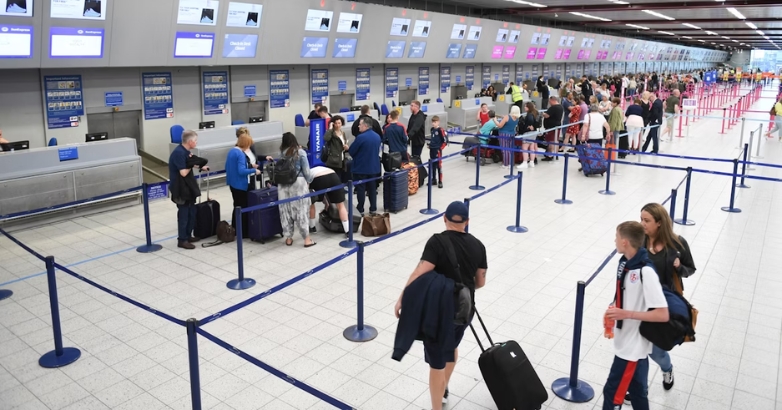 Families with children wait in line at an airport, preparing for stress-free air travel.